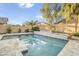 Beautiful backyard pool with travertine decking and lush landscaping at 8630 W Apache St, Tolleson, AZ 85353