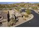 Aerial view of a desert home featuring desert landscaping, a tile roof, and a circular street at 8634 E Kael Cir, Mesa, AZ 85207