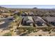 Aerial view of a desert neighborhood featuring homes with tile roofs and desert landscaping at 8634 E Kael Cir, Mesa, AZ 85207