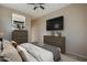 Nicely staged bedroom features a television, dresser, and calming neutral tones at 8634 E Kael Cir, Mesa, AZ 85207