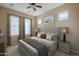 Well-lit bedroom featuring window coverings, a ceiling fan, and ample natural light at 8634 E Kael Cir, Mesa, AZ 85207