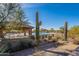 Community pool featuring shaded seating areas, desert landscaping, and a tranquil environment for residents at 8634 E Kael Cir, Mesa, AZ 85207