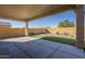 Enjoy the covered patio area with desert landscaping and privacy wall at 8634 E Kael Cir, Mesa, AZ 85207