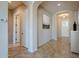 Open hallway featuring neutral walls, tile flooring, and archways leading to other areas of the home at 8634 E Kael Cir, Mesa, AZ 85207