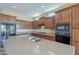 Kitchen featuring dark cabinets, light countertops, stainless steel appliances, and ample storage space at 8634 E Kael Cir, Mesa, AZ 85207