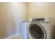 Convenient laundry room with a modern washer and dryer set at 8634 E Kael Cir, Mesa, AZ 85207