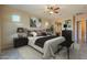 Relaxing main bedroom featuring neutral walls, accent art and a decorative ceiling fan at 8634 E Kael Cir, Mesa, AZ 85207