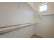 Spacious walk-in closet featuring built-in shelving and a window for natural light at 8634 E Kael Cir, Mesa, AZ 85207