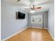 This bedroom features hardwood floors, ceiling fan, and a window with curtains at 9001 W Lone Cactus Dr, Peoria, AZ 85382