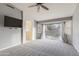 Bedroom with carpet, TV, and large windows at 9001 W Lone Cactus Dr, Peoria, AZ 85382