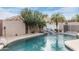 Backyard swimming pool with waterfall feature, mature trees, and privacy walls at 9001 W Lone Cactus Dr, Peoria, AZ 85382