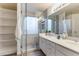 Bright bathroom with dual sinks, marble countertops, and a glass-enclosed shower at 9144 W Quail Ave, Peoria, AZ 85382