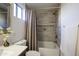 Bathroom featuring a bathtub with a shower and decorative gray tile at 9144 W Quail Ave, Peoria, AZ 85382