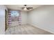 Neutral bedroom with carpet, ceiling fan, and a lovely arched window at 9144 W Quail Ave, Peoria, AZ 85382