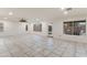 A bright, open living room with tile flooring, many windows, and a view of the pool at 9144 W Quail Ave, Peoria, AZ 85382