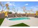 Backyard with a pristine pool surrounded by lounge chairs and tables at 9144 W Quail Ave, Peoria, AZ 85382