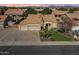 Beautiful aerial view of a single-story home with a three-car garage and desert landscaping in a serene neighborhood at 9544 E Irwin Ave, Mesa, AZ 85209