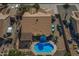 Aerial view of a private backyard featuring a sparkling pool, covered patio, and lush landscaping at 9544 E Irwin Ave, Mesa, AZ 85209