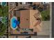 Aerial view showcases a home with a private pool, lush landscaping, and a well-maintained tile roof at 9544 E Irwin Ave, Mesa, AZ 85209