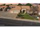 Gorgeous aerial view of a single-story home with a three-car garage, desert landscaping, and a clay tile roof at 9544 E Irwin Ave, Mesa, AZ 85209