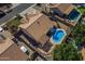 Aerial view of a private backyard featuring a sparkling pool, covered patio, and lush landscaping at 9544 E Irwin Ave, Mesa, AZ 85209