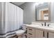 Bathroom featuring a shower with blue striped curtain, vanity and framed mirror at 9544 E Irwin Ave, Mesa, AZ 85209