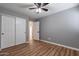 Bedroom with laminate floors, double door closet, and ensuite bathroom at 9544 E Irwin Ave, Mesa, AZ 85209