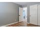 Bedroom with laminate floors, double door closet, and ensuite bathroom at 9544 E Irwin Ave, Mesa, AZ 85209