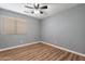 Bedroom featuring neutral walls, laminate floors, and a ceiling fan at 9544 E Irwin Ave, Mesa, AZ 85209