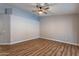 Empty bedroom showcasing wood-look floors, neutral walls and ceiling fan at 9544 E Irwin Ave, Mesa, AZ 85209