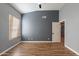 Cozy bedroom with neutral gray walls, laminate floors and large window with blinds at 9544 E Irwin Ave, Mesa, AZ 85209