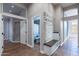 Hallway with stone accent wall, bench seating and access to the bathroom at 9544 E Irwin Ave, Mesa, AZ 85209