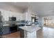 Modern kitchen featuring white cabinetry, gray accents, stainless steel appliances, and a stone-accented island at 9544 E Irwin Ave, Mesa, AZ 85209