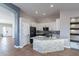 Modern kitchen with a stone-clad island, white cabinets, and sleek appliances at 9544 E Irwin Ave, Mesa, AZ 85209