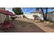 Landscaped backyard with stone pavers and white fencing at 9614 W Mary Ann Dr, Peoria, AZ 85382