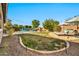 This backyard paradise includes a pristine pool with rock waterfall feature and lounging areas at 9388 W Cashman Dr, Peoria, AZ 85383