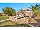 Backyard lounge area featuring stylish patio furniture, shade umbrellas, and well-maintained landscaping at 9388 W Cashman Dr, Peoria, AZ 85383