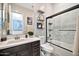 Bathroom showcasing a modern vanity, a framed mirror, and a separate tiled shower-tub for a luxurious feel at 9388 W Cashman Dr, Peoria, AZ 85383