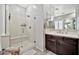Bathroom with a glass enclosed walk-in shower, and a dark wood vanity with double sinks at 9388 W Cashman Dr, Peoria, AZ 85383