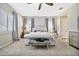 A beautiful bedroom with a tufted headboard bed, plush gray carpeting, and neutral gray walls at 9388 W Cashman Dr, Peoria, AZ 85383