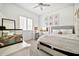 Bright bedroom features a cozy bed, a lit vanity, and a window for natural light, creating a serene retreat at 9388 W Cashman Dr, Peoria, AZ 85383