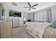 Cozy bedroom with light gray carpet, a comfortable bed and TV, and a ceiling fan at 9388 W Cashman Dr, Peoria, AZ 85383