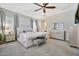 Inviting bedroom featuring a tufted headboard bed, mirrored dressers, and neutral decor at 9388 W Cashman Dr, Peoria, AZ 85383