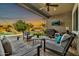 An open-air patio with comfortable seating, a fan, and outdoor TV is perfect for gatherings and relaxing at 9388 W Cashman Dr, Peoria, AZ 85383
