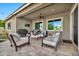 Cozy covered patio area with comfortable seating, a ceiling fan, and outdoor entertainment setup at 9388 W Cashman Dr, Peoria, AZ 85383