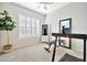 Home exercise area with large window with shutter style shades, a treadmill, and a weight bench at 9388 W Cashman Dr, Peoria, AZ 85383