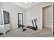 Brightly lit exercise room with mirror, bench, and treadmill for at-home workouts at 9388 W Cashman Dr, Peoria, AZ 85383