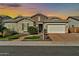 Charming single-story home features stone accents, a two-car garage, and well-maintained landscaping at 9388 W Cashman Dr, Peoria, AZ 85383