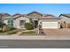 Charming single-story home features stone accents, a two-car garage, and well-maintained landscaping at 9388 W Cashman Dr, Peoria, AZ 85383