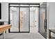 Hallway showcases glass doors with black trim, seamlessly connecting spaces with a modern aesthetic at 9388 W Cashman Dr, Peoria, AZ 85383